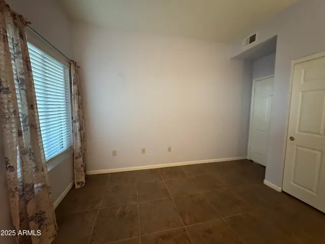 a bathroom with a granite countertop toilet a sink and a mirror