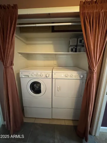 a view of an empty room with window and cabinet