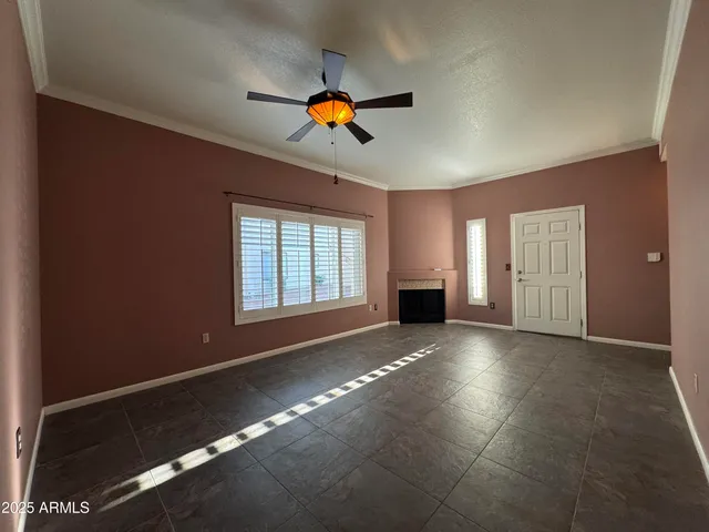 a view of an empty room with window and cabinet