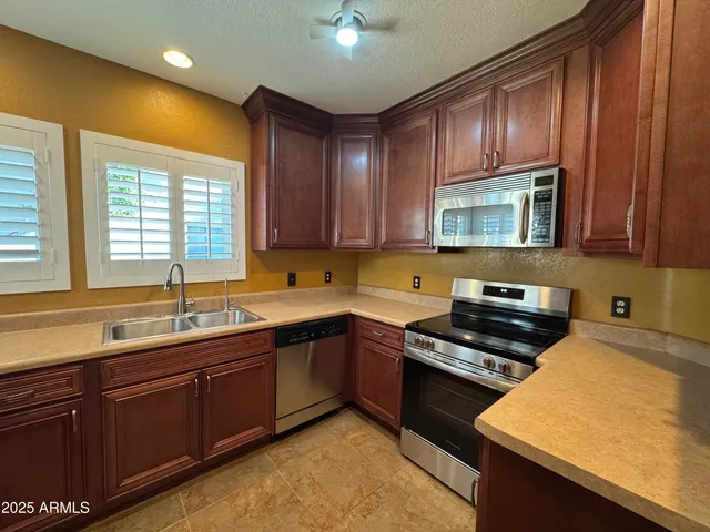 a kitchen with wooden cabinets and a sink
