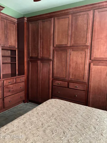 a room with a dresser and a window
