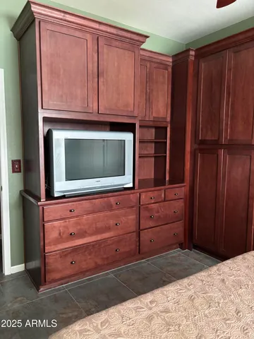 a view of a dresser with wooden cabinets