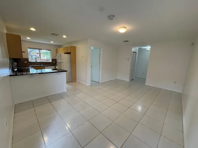 a view of kitchen with stainless steel appliances a sink and cabinets