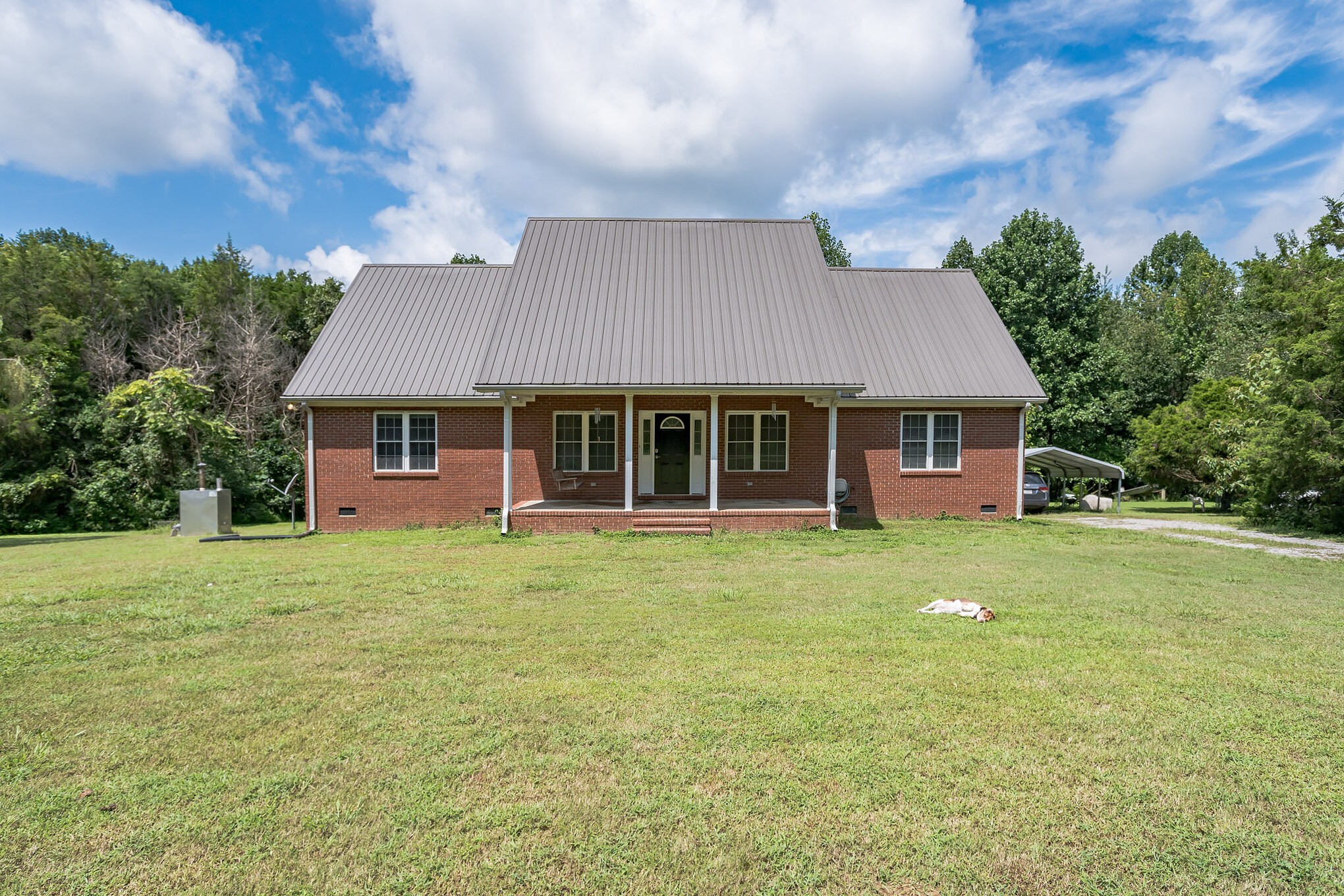 420 Sands Road Pulaski, TN 38478 - Photo 1 of 36 a front view of a house with a garden