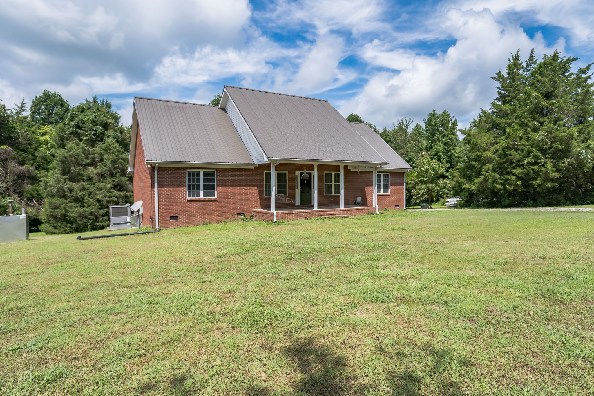 420 Sands Road Pulaski, TN 38478 - Photo 2 of 36 a front view of a house with a garden