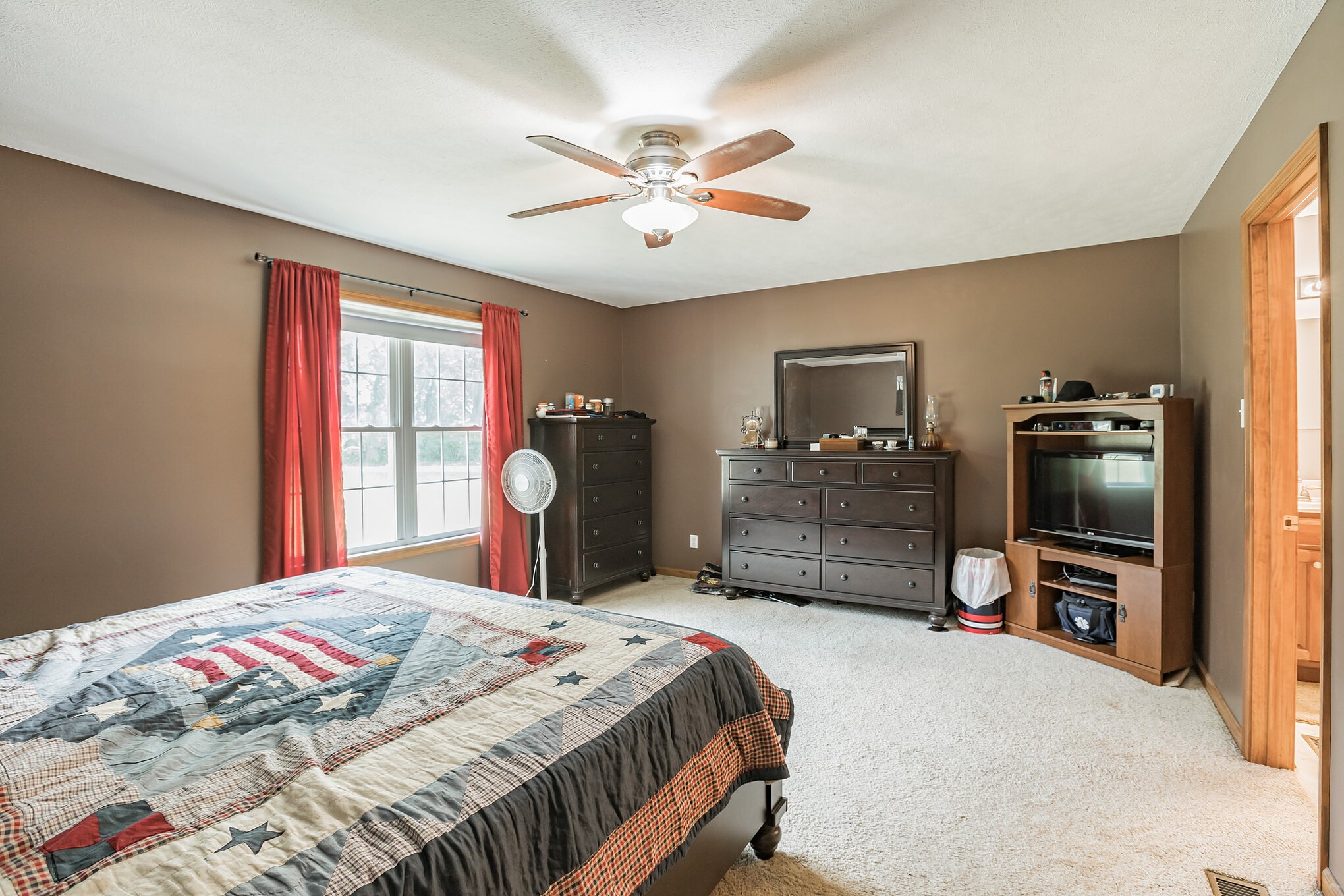 420 Sands Road Pulaski, TN 38478 - Photo 19 of 36 a bedroom with a bed and a flat tv screen on dresser