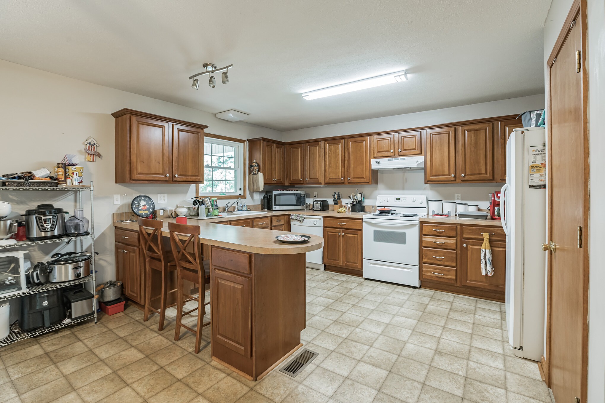 420 Sands Road Pulaski, TN 38478 - Photo 29 of 36 a kitchen with a stove a sink and a refrigerator