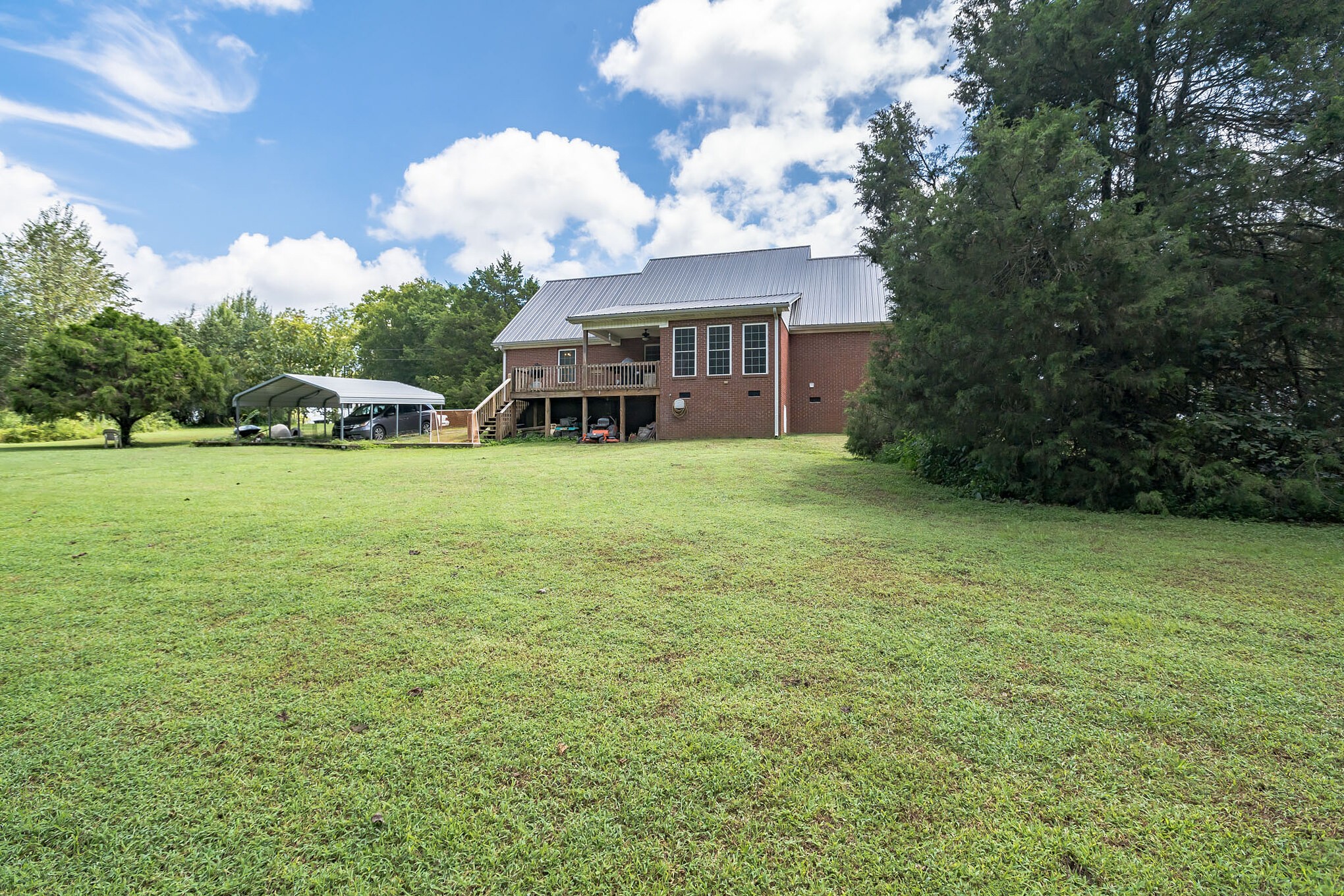 420 Sands Road Pulaski, TN 38478 - Photo 6 of 36 a view of a house with a big yard and large trees