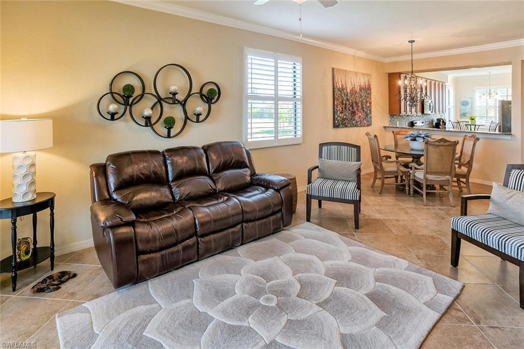 9719 Acqua Court, Unit 228 Naples, FL 34113 - Photo 5 of 35 a living room with furniture and a large window