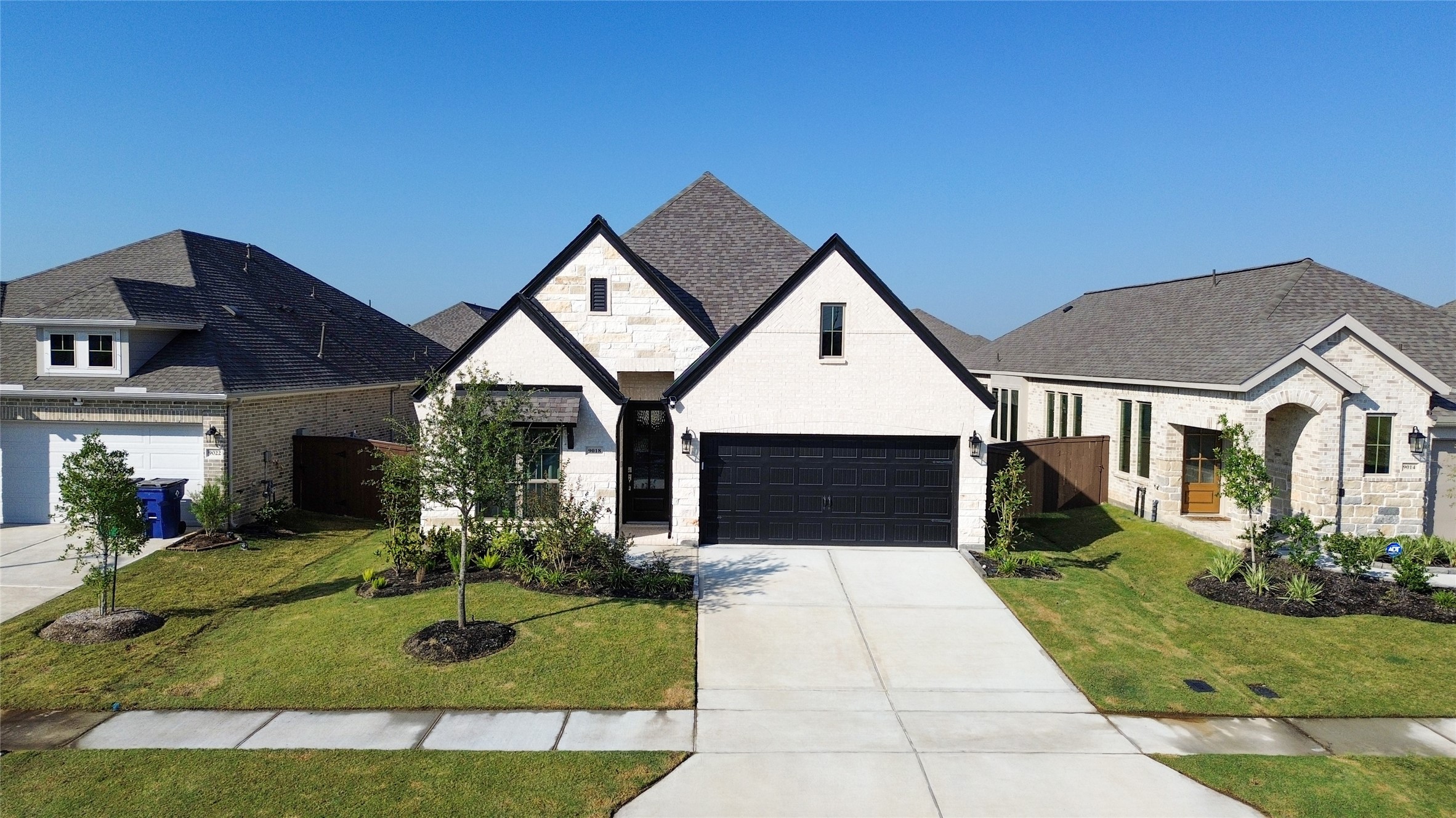 9018 Moose Trail Manvel, TX 77578 - Photo 1 of 37 a front view of a house with garden
