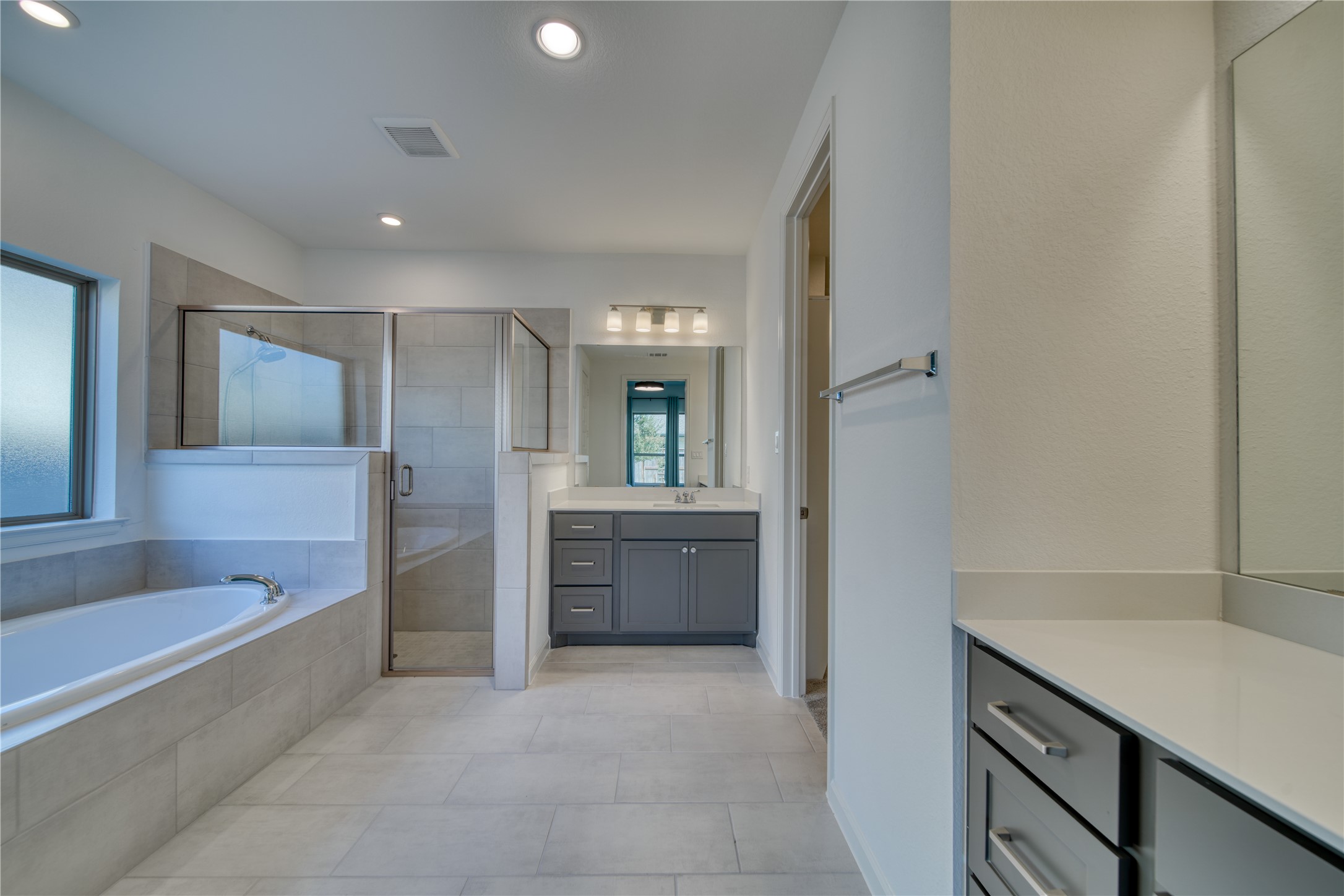 9018 Moose Trail Manvel, TX 77578 - Photo 18 of 37 a bathroom with a tub sink and mirror