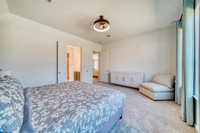 a spacious bedroom with a bed and a couch