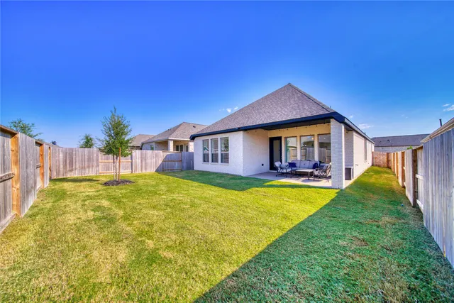 a view of a house with swimming pool and a yard