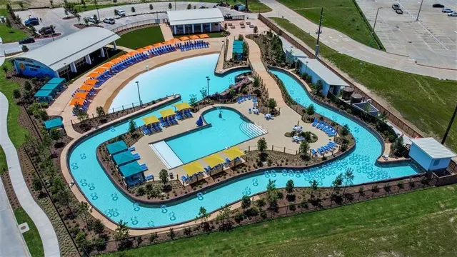 a view of a swimming pool with an outdoor seating and a garden