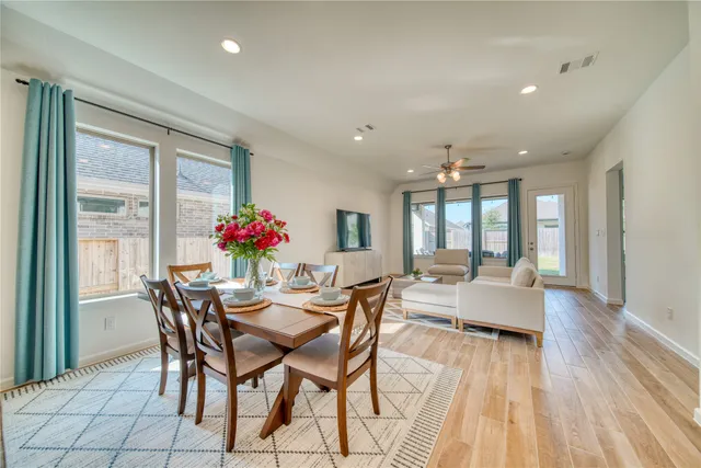 a view of a dining room with furniture wooden floor and chandelier
