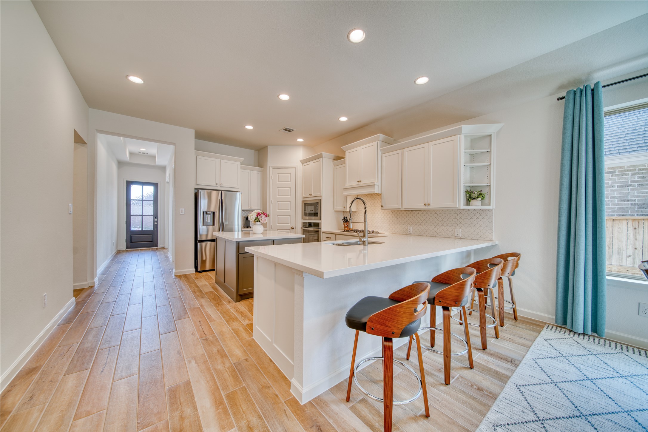 9018 Moose Trail Manvel, TX 77578 - Photo 6 of 37 a large kitchen with stainless steel appliances kitchen island granite countertop a large island in the center