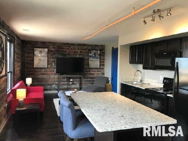 501 15th Street, Unit 802 Moline, IL 61265 - Photo 2 of 6 a kitchen with granite countertop a stove a sink and a refrigerator