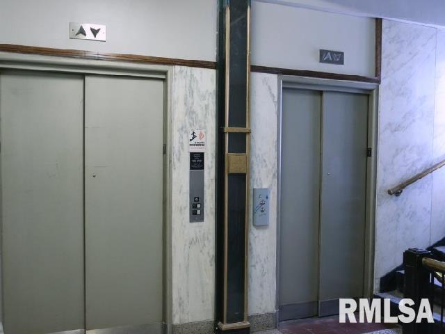 501 15th Street, Unit 802 Moline, IL 61265 - Photo 5 of 6 a view of a closet area with wooden floor