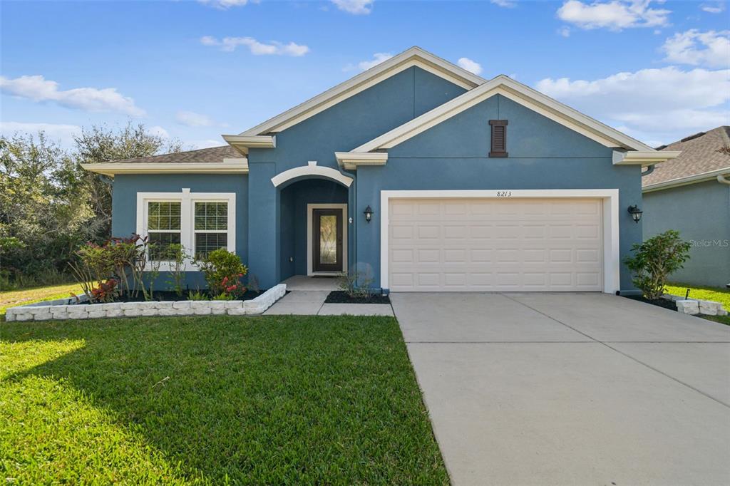 a front view of a house with a yard and garage