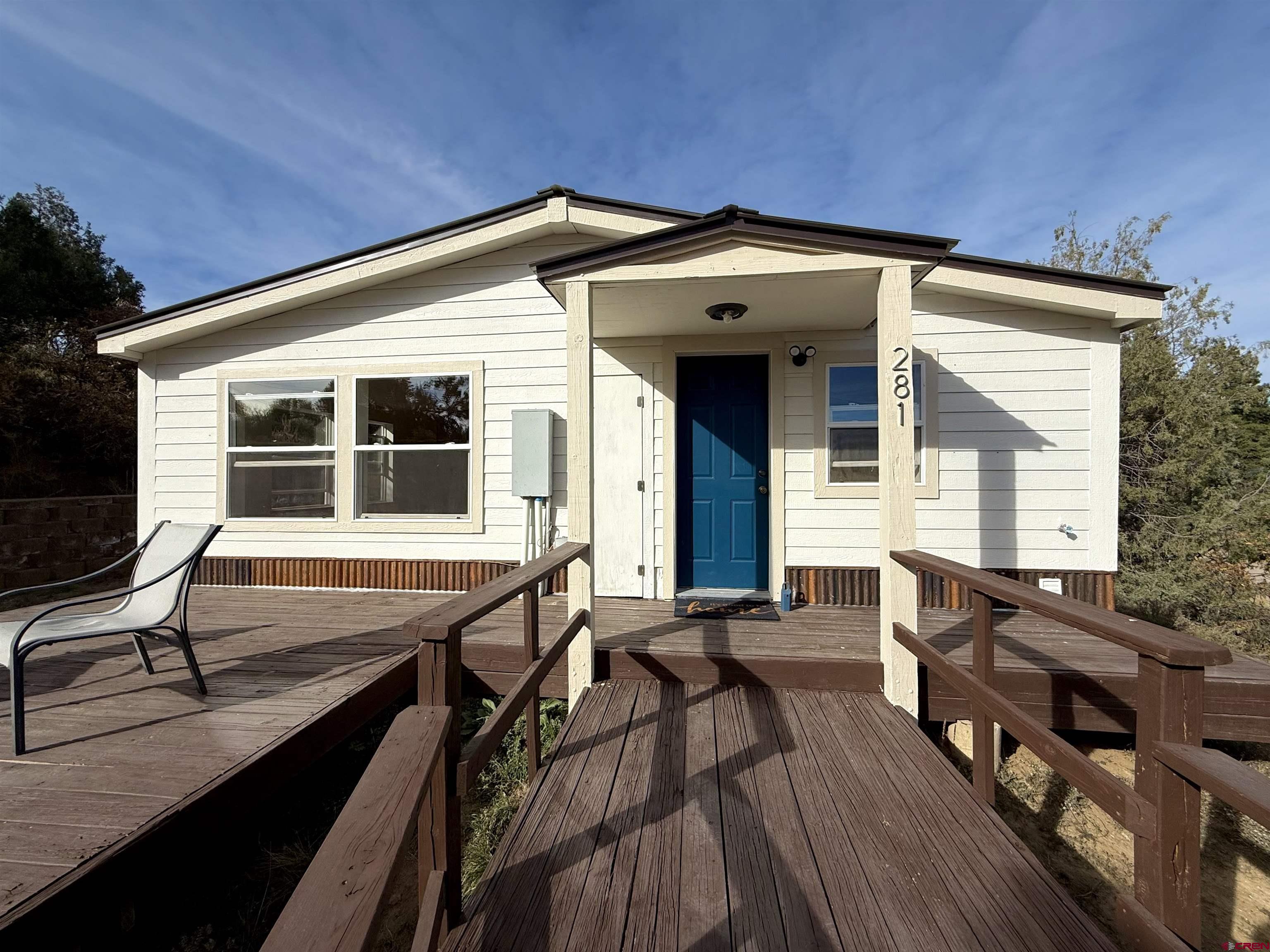 a view of house with deck and outdoor seating