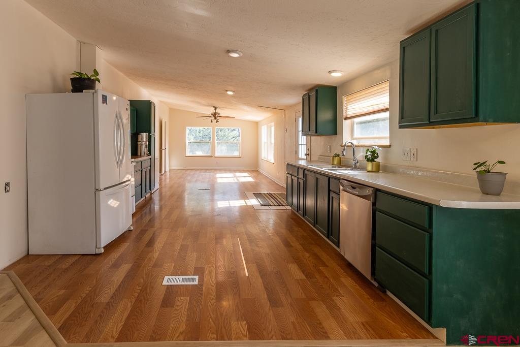 281 Alpine Drive Durango, CO 81301 - Photo 11 of 42 a kitchen with wooden floors and stainless steel appliances