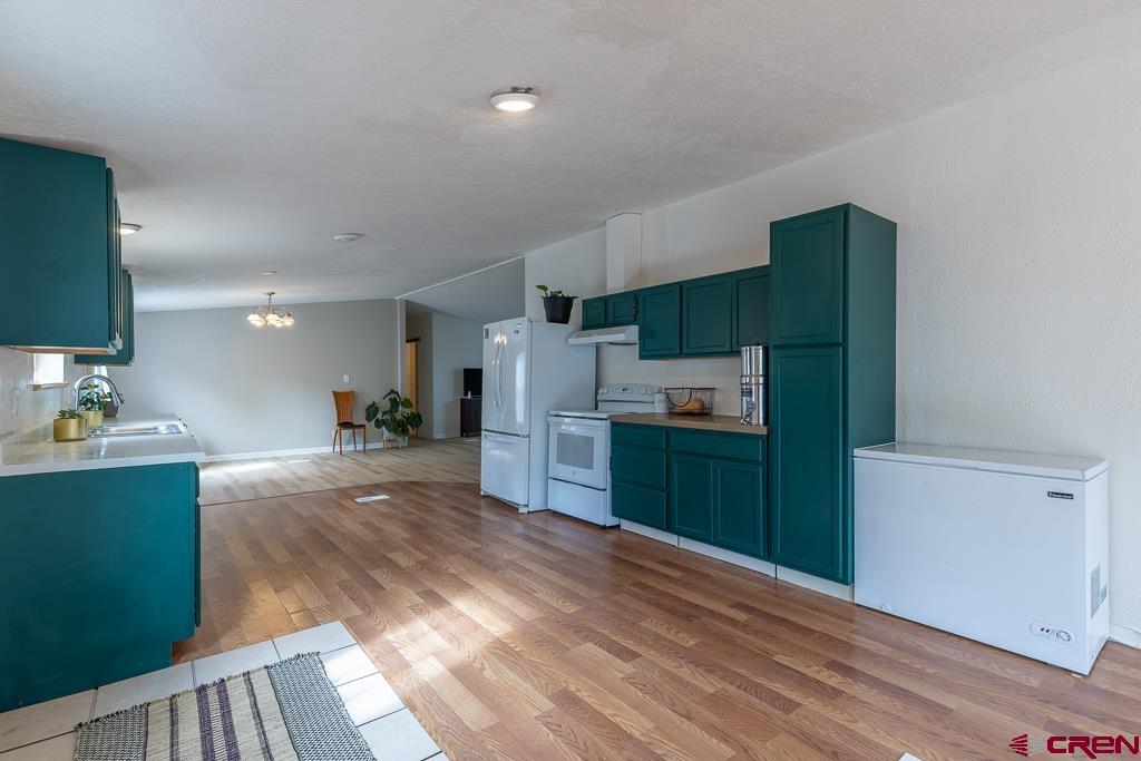 281 Alpine Drive Durango, CO 81301 - Photo 17 of 42 a kitchen with stainless steel appliances a refrigerator sink and microwave