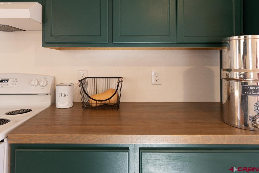 281 Alpine Drive Durango, CO 81301 - Photo 18 of 42 a kitchen with a refrigerator and a stove top oven