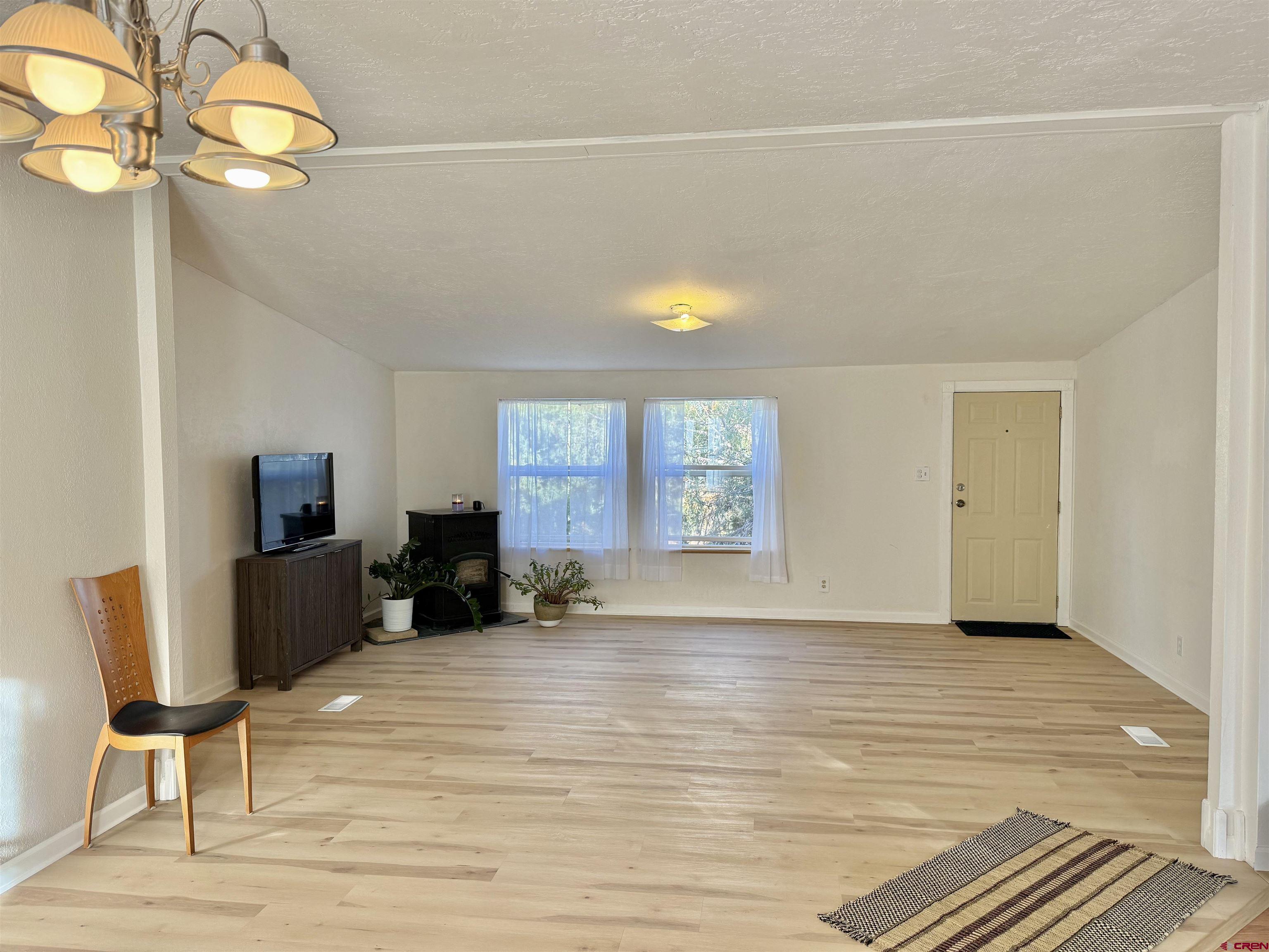 281 Alpine Drive Durango, CO 81301 - Photo 25 of 42 a view of a livingroom with wooden floor and a flat screen tv