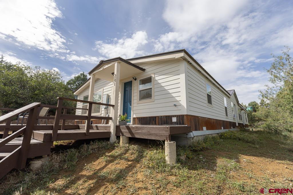 281 Alpine Drive Durango, CO 81301 - Photo 3 of 42 a front view of a house with a yard