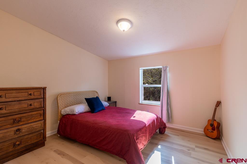 281 Alpine Drive Durango, CO 81301 - Photo 33 of 42 a bedroom with a bed and wooden floor
