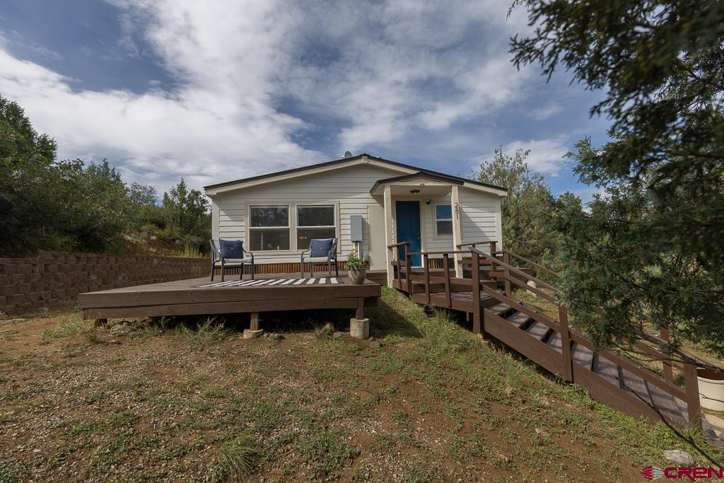 281 Alpine Drive Durango, CO 81301 - Photo 40 of 42 a backyard of a house with wooden deck and outdoor seating