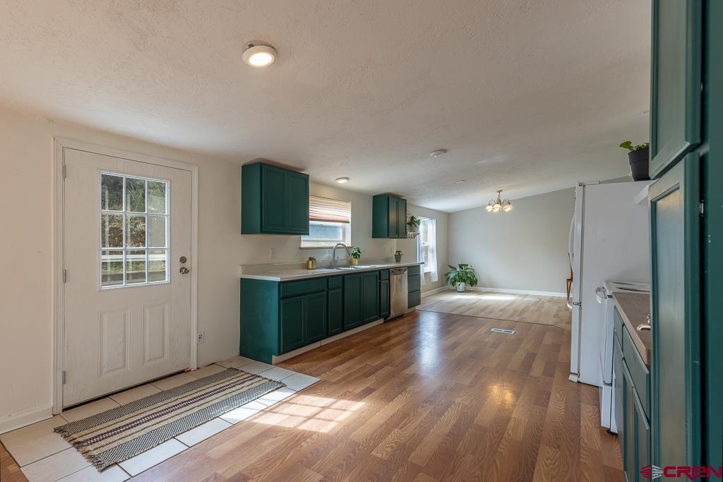 281 Alpine Drive Durango, CO 81301 - Photo 8 of 42 a kitchen with a refrigerator and a sink