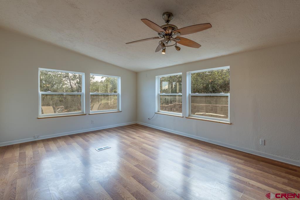 281 Alpine Drive Durango, CO 81301 - Photo 10 of 42 a view of empty room with wooden floor and fan