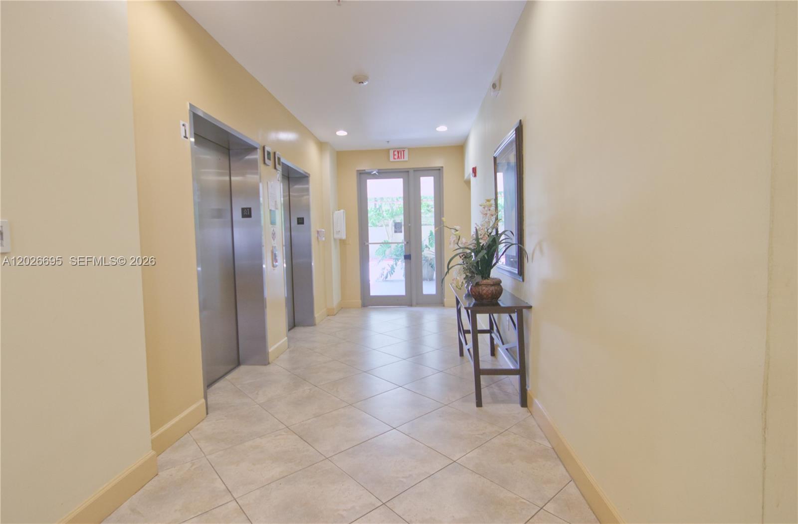 2630 Southwest 28th Street, Unit 22 Miami, FL 33133 - Photo 6 of 9 a view of hallway with furniture and windows