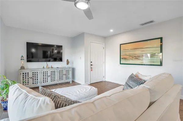 a living room with furniture and kitchen view