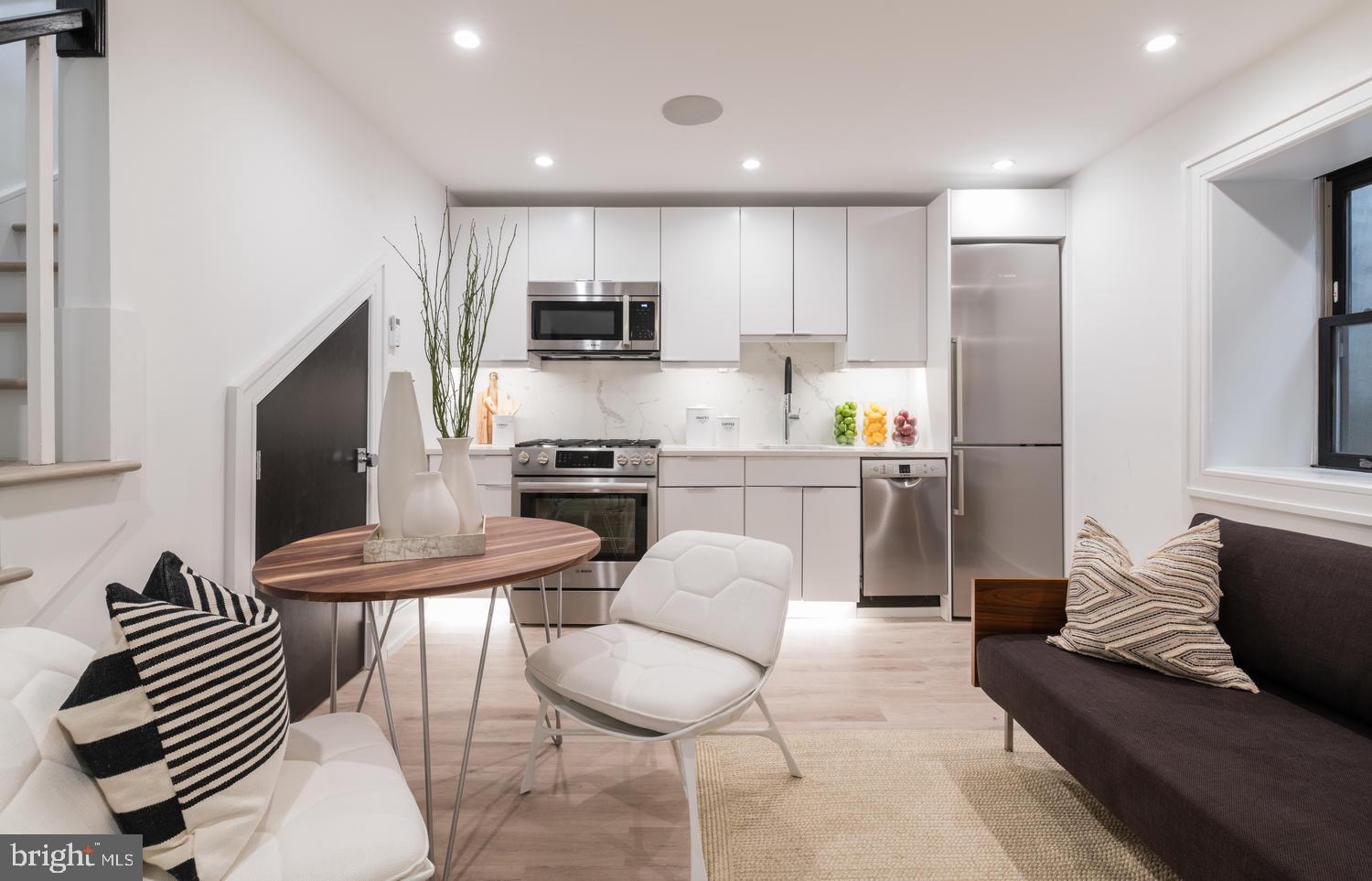 1524 18th Street Northwest, Unit 1 Washington, DC 20036 - Photo 12 of 20 a kitchen with stainless steel appliances kitchen island granite countertop a refrigerator and a stove top oven