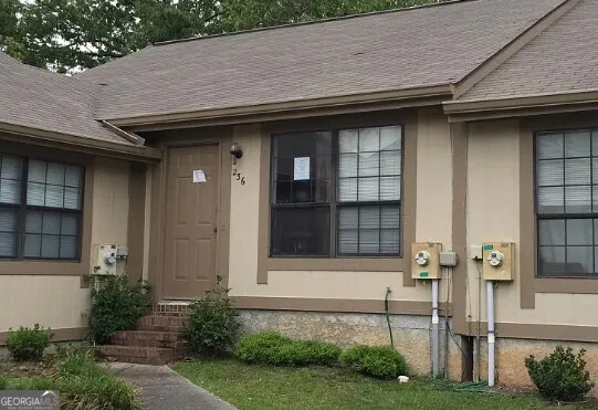 a front view of a house with a garden