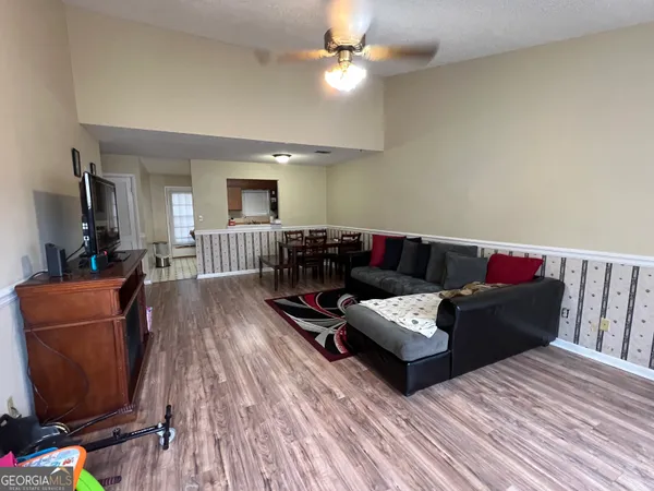 a living room with furniture and wooden floor