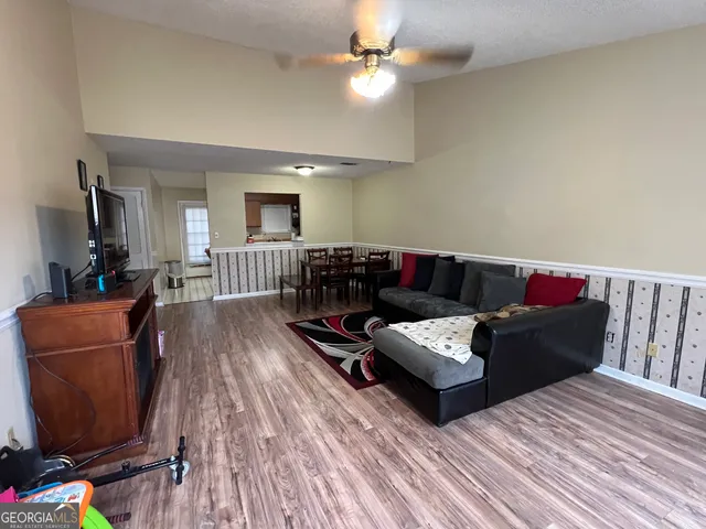 a living room with furniture and wooden floor