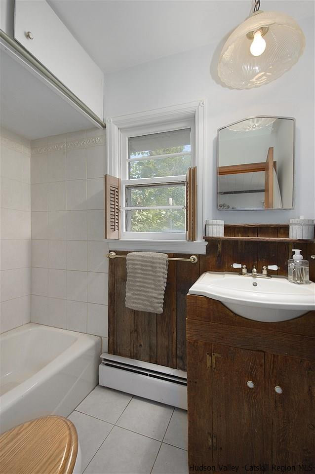8 Jansen Road Stone Ridge, NY 12484 - Photo 15 of 28 a bathroom with a bathtub sink and mirror