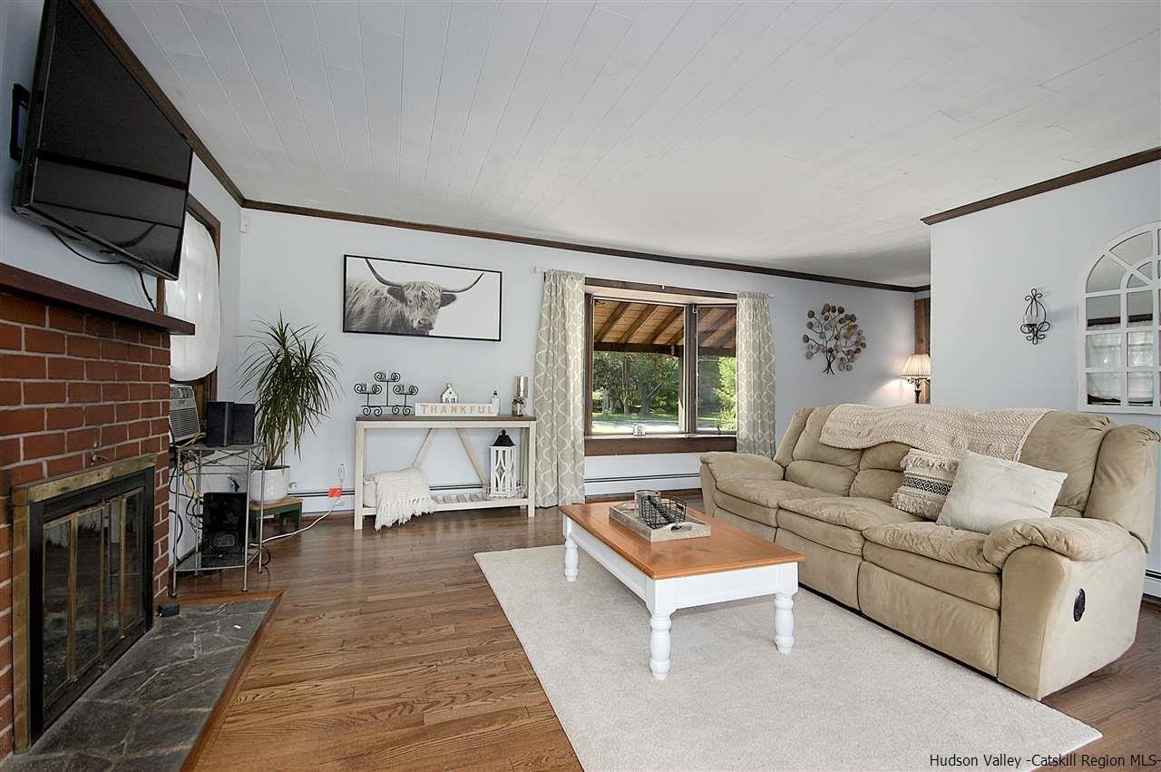 8 Jansen Road Stone Ridge, NY 12484 - Photo 5 of 28 a living room with furniture a rug and a fireplace