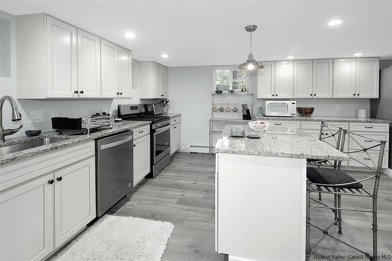 8 Jansen Road Stone Ridge, NY 12484 - Photo 9 of 28 a kitchen with stainless steel appliances granite countertop a sink stove and refrigerator