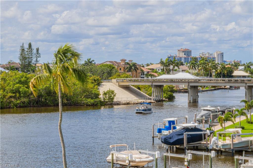 21 Bluebill Avenue, Unit 902 Naples, FL 34108 - Photo 9 of 44 View of dock featuring a water view