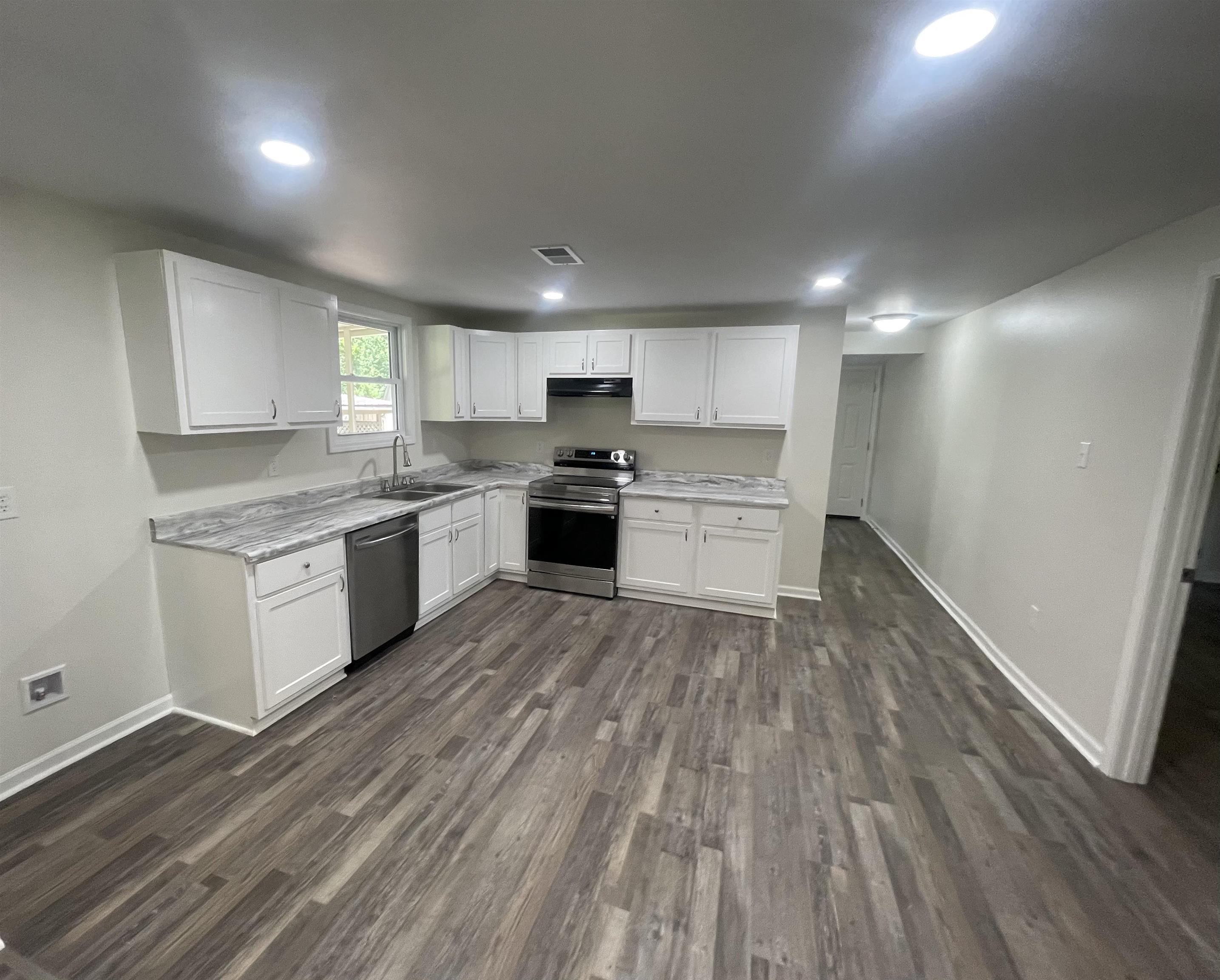 815 Fawn Road Oakland, TN 38060 - Photo 11 of 29 Kitchen with appliances with stainless steel finishes, light countertops, a sink, dark wood-style flooring, and recessed lighting