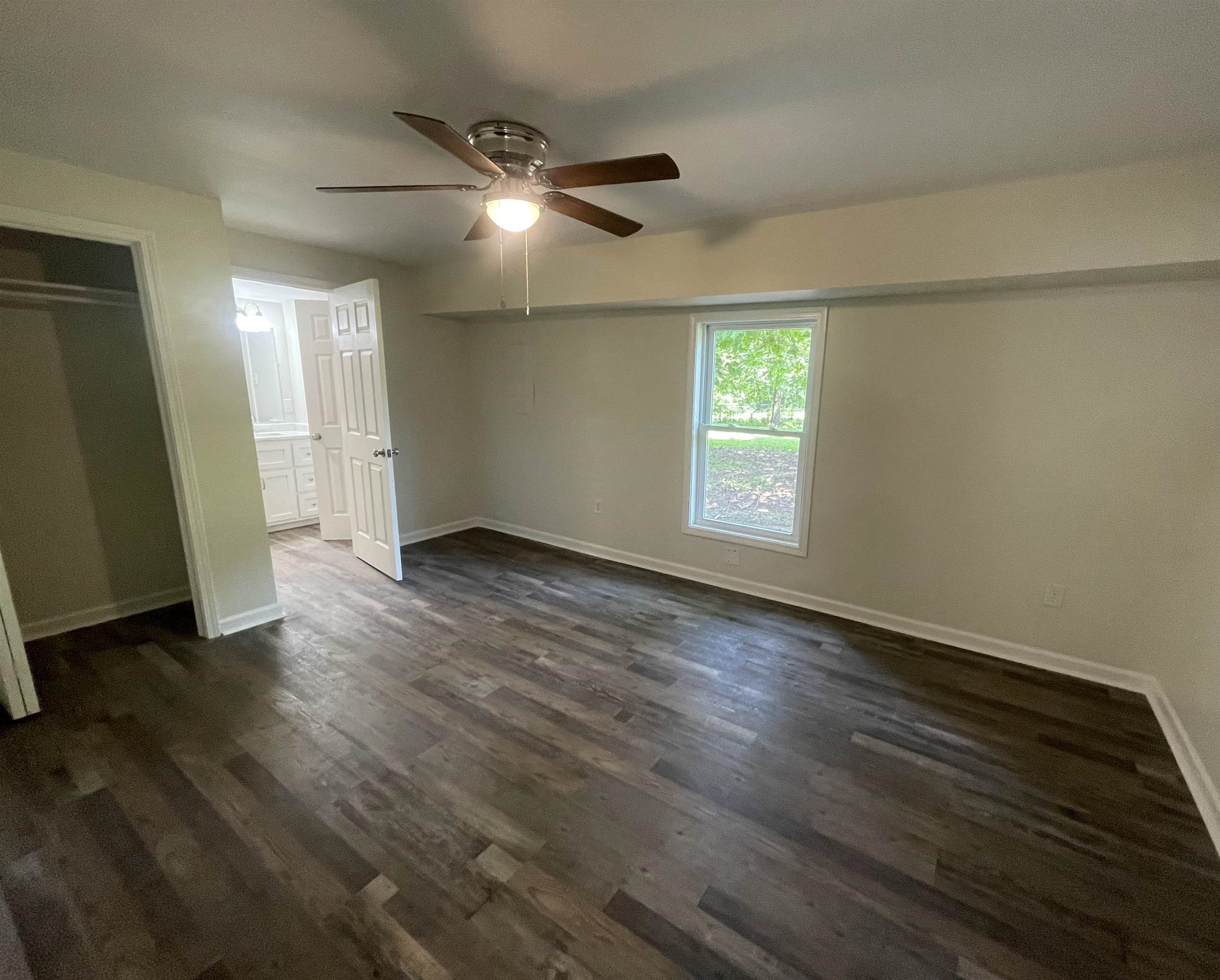 815 Fawn Road Oakland, TN 38060 - Photo 15 of 29 Master Bedroomwith baseboards, dark wood-style flooring, and a ceiling fan