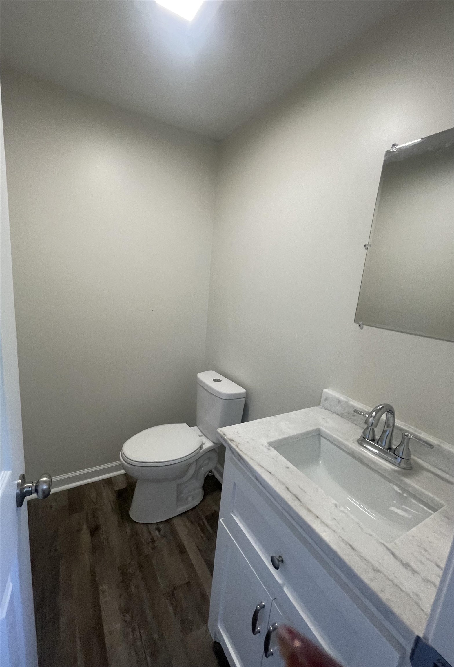 815 Fawn Road Oakland, TN 38060 - Photo 20 of 29 Half bath with toilet, vanity, and wood finished floors