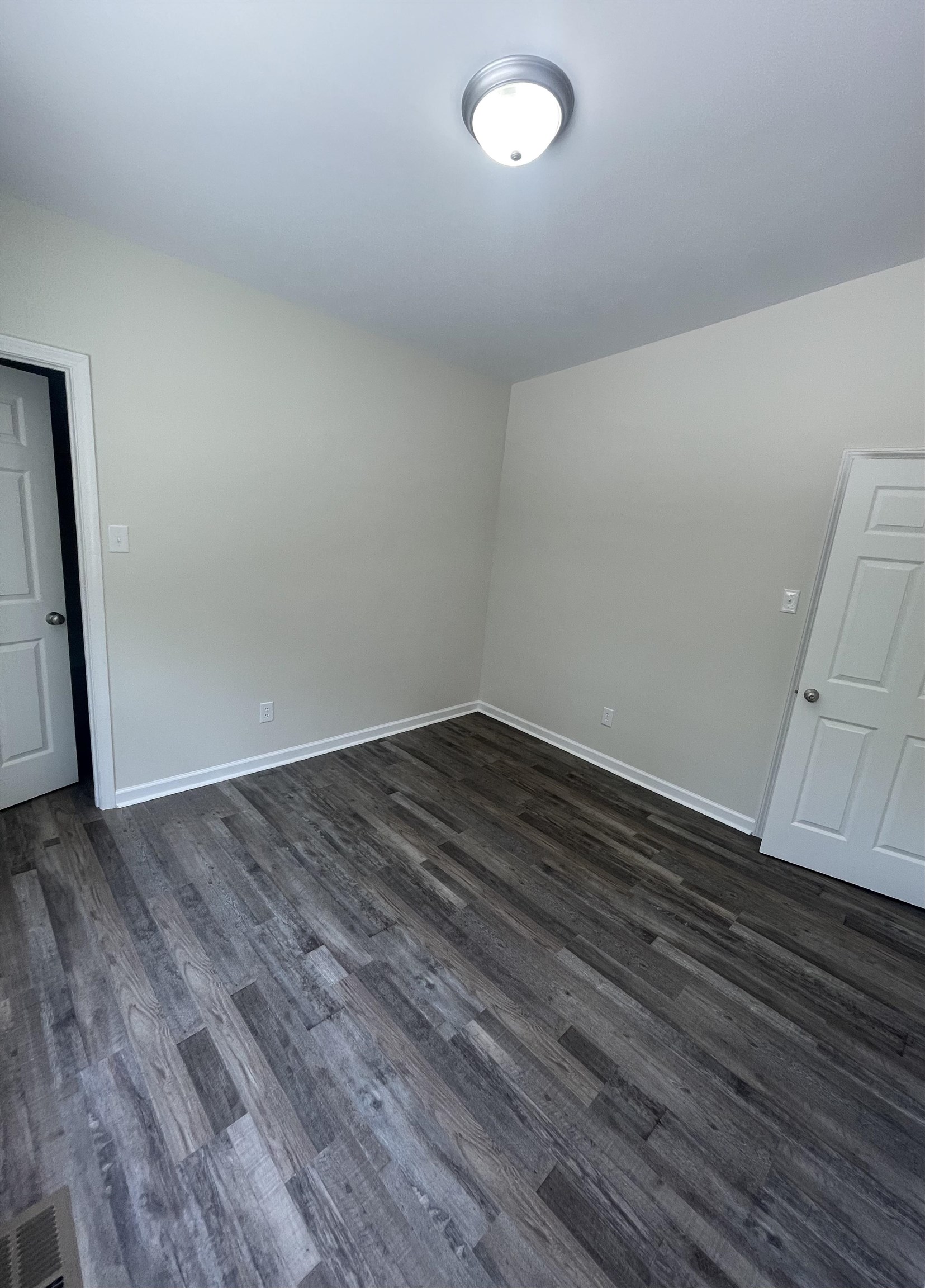 815 Fawn Road Oakland, TN 38060 - Photo 23 of 29 Spare room featuring dark wood-style floors and baseboards