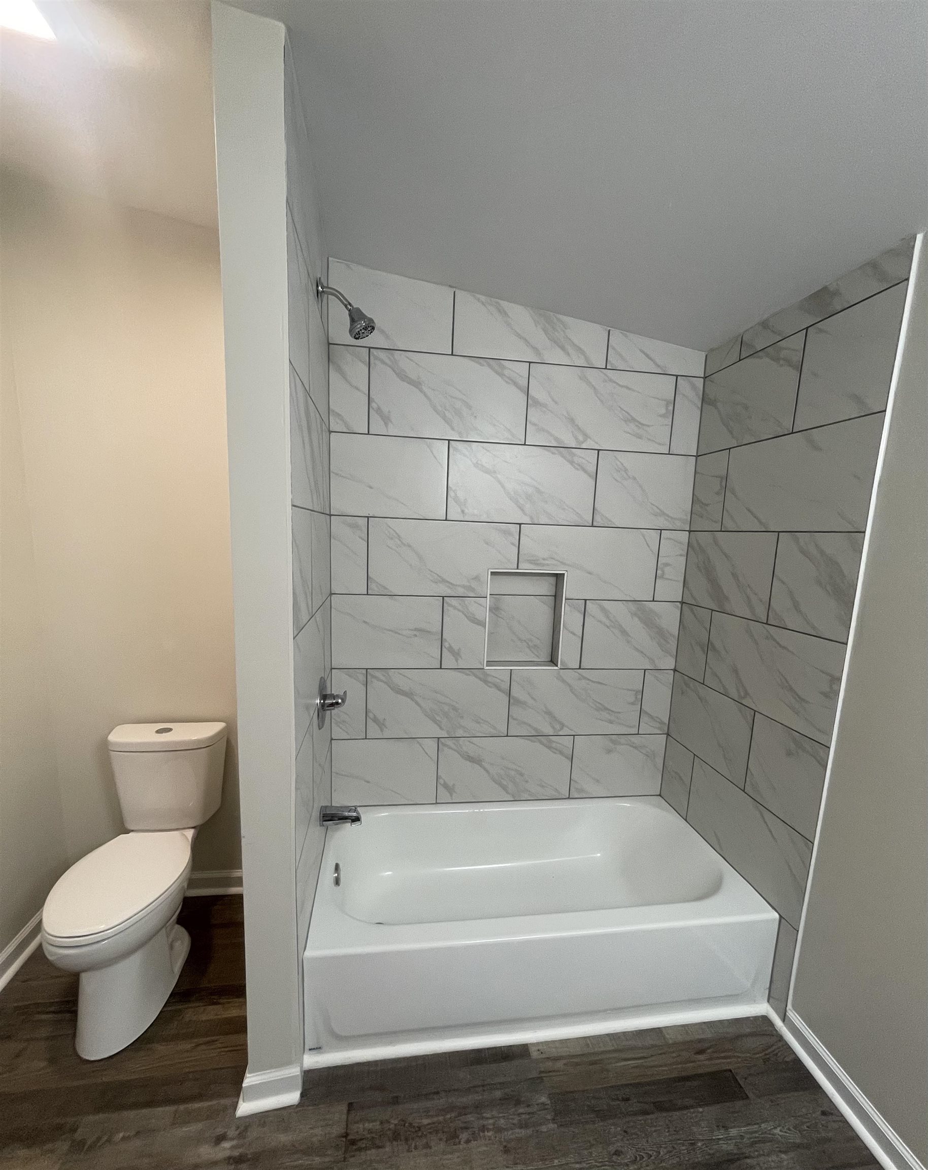 815 Fawn Road Oakland, TN 38060 - Photo 26 of 29 Bathroom with toilet, wood finished floors, bathtub / shower combination, and baseboards