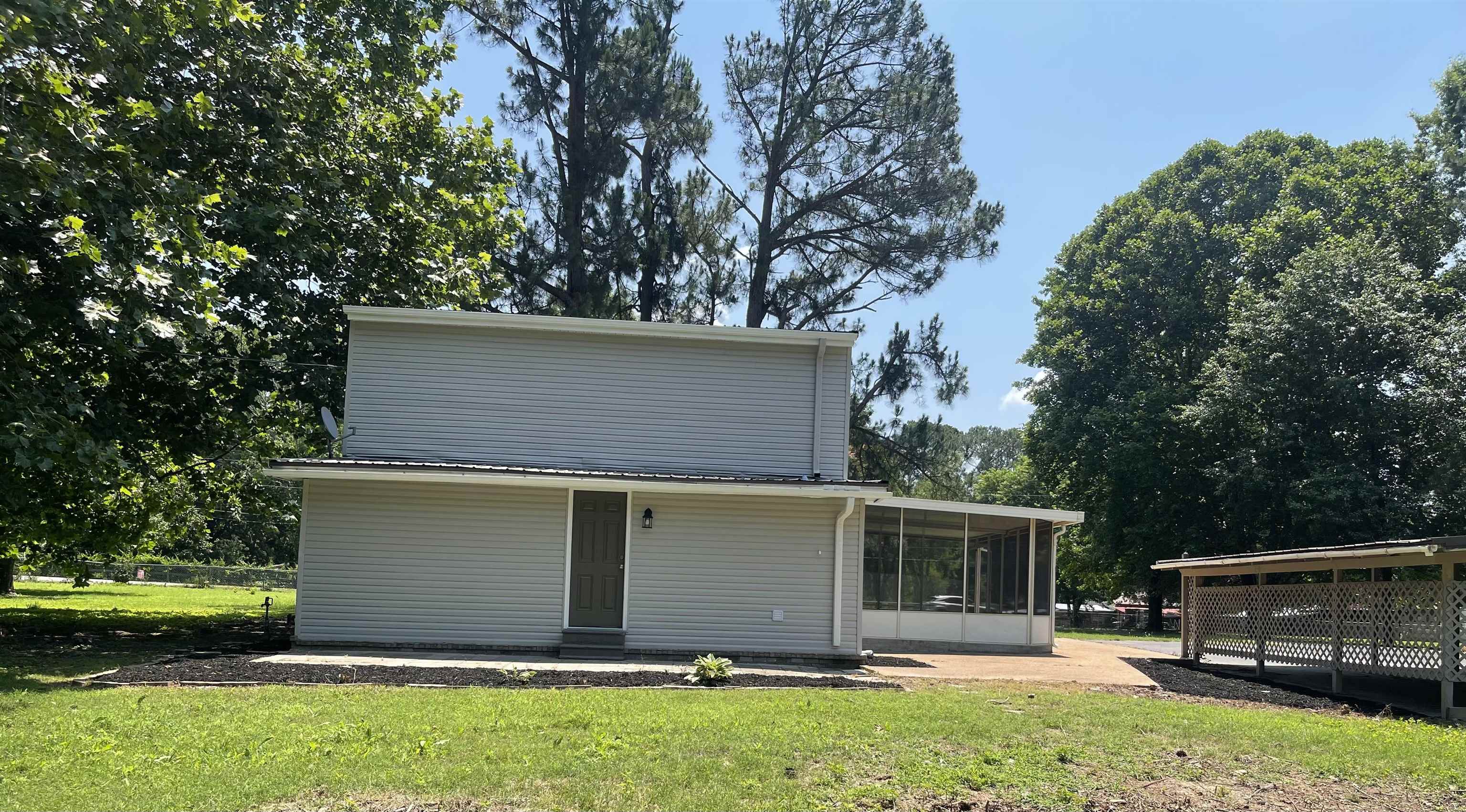 815 Fawn Road Oakland, TN 38060 - Photo 5 of 29 Rear view of property with a sunroom and a lawn