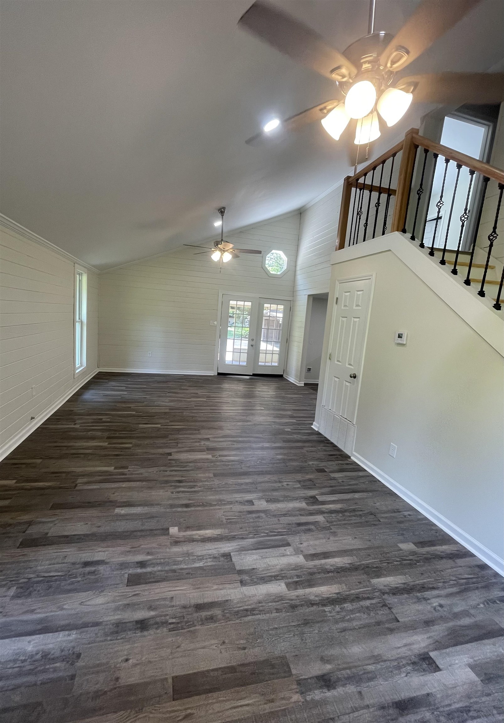 815 Fawn Road Oakland, TN 38060 - Photo 8 of 29 Unfurnished living room featuring a ceiling fan, dark wood-style floors, baseboards, stairs, and high vaulted ceiling
